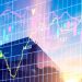 A modern glass building is shown at sunset with colorful financial charts, graphs, and stock market data overlaid transparently across the image. | ZIIMP
